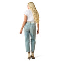 Woman wearing light blue jeans and a white top on a white background