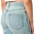 Light blue denim jeans with a white background
