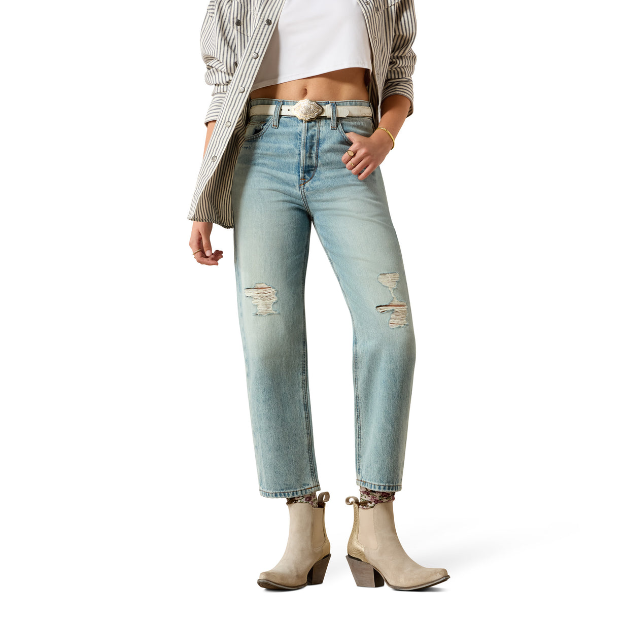 Person wearing light blue distressed jeans with a white background