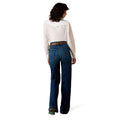 Person wearing blue jeans and a white shirt on a white background
