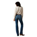 Person wearing a white shirt and blue jeans on a white background