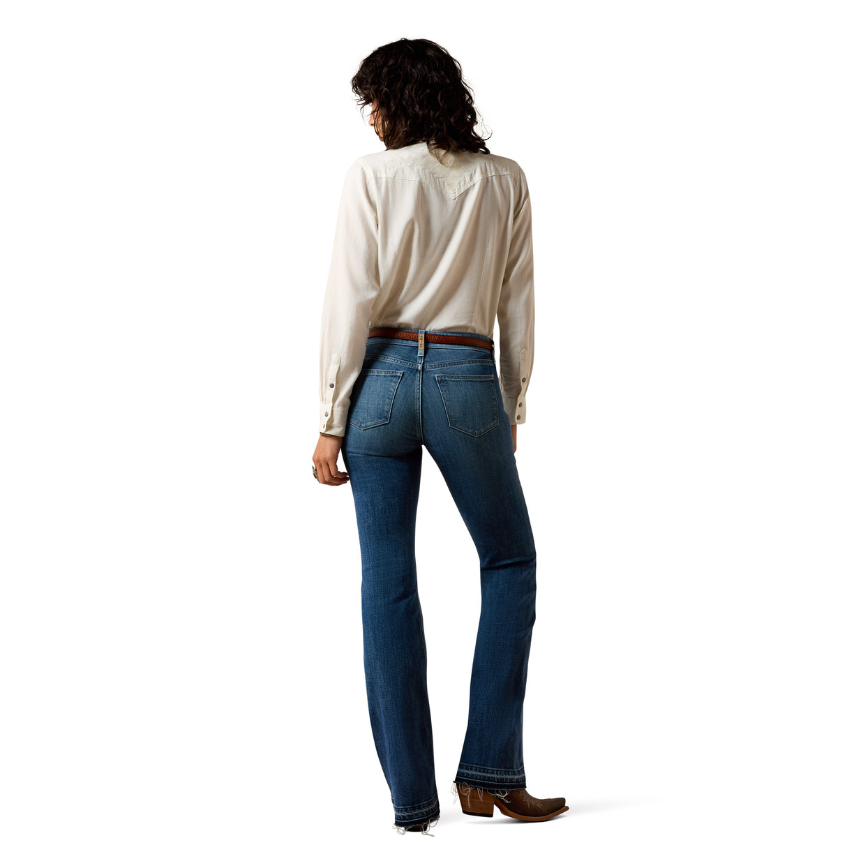 Person wearing a white shirt and blue jeans on a white background