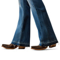 Close-up of blue jeans and brown cowboy boots on a white background