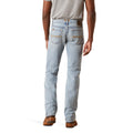 Light blue jeans worn by a person on a white background