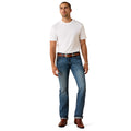 Man wearing a white t-shirt and blue jeans on a white background