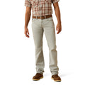 Person wearing light-colored jeans and a plaid shirt on a white background