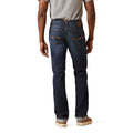 Person wearing dark blue jeans on a white background