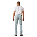 Man wearing light blue jeans and a white t-shirt on a white background