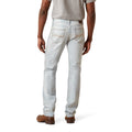 Person wearing light blue jeans on a white background