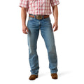 Person wearing blue jeans and a red plaid shirt on a white background
