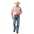 Man wearing a red plaid shirt, blue jeans, and a cowboy hat on a white background