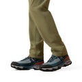Close-up of hiking shoes and pants on a white background