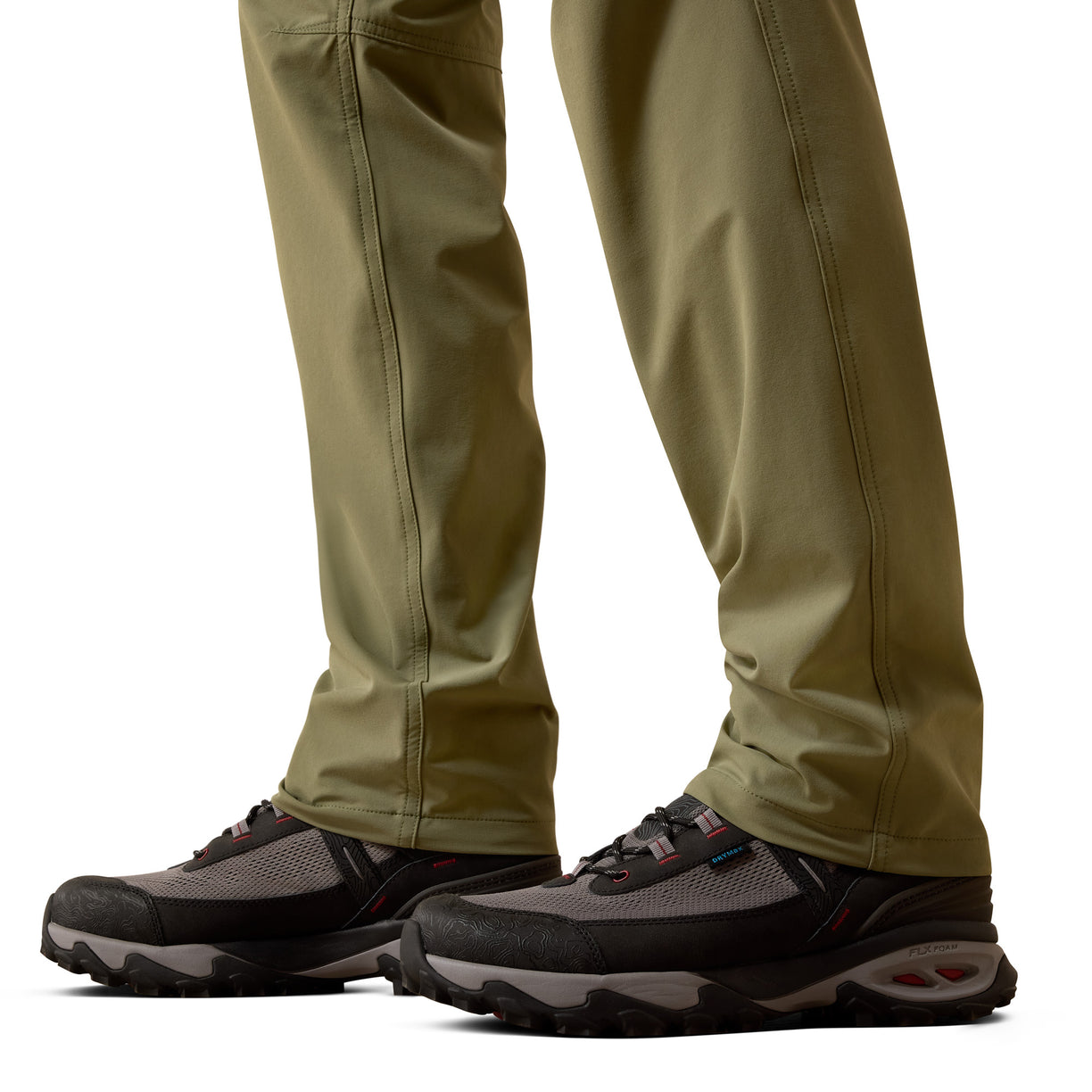 Close-up of beige pants and black hiking shoes on a white background