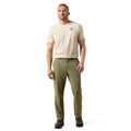 Man wearing a beige t-shirt and olive green pants on a white background