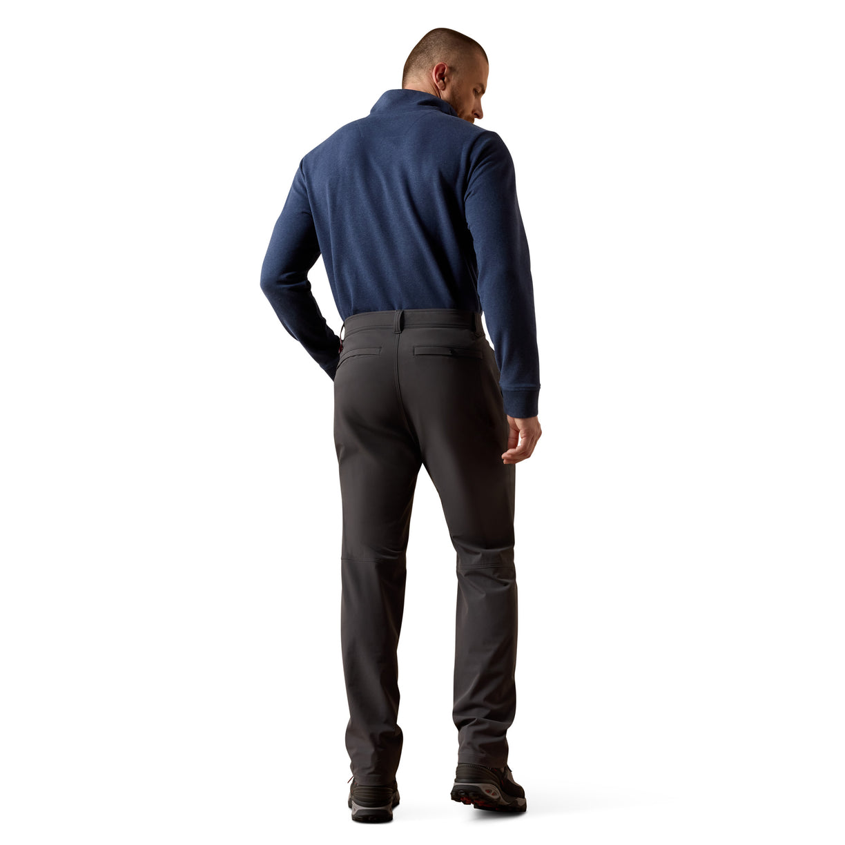 Man wearing a blue shirt and black pants on a white background
