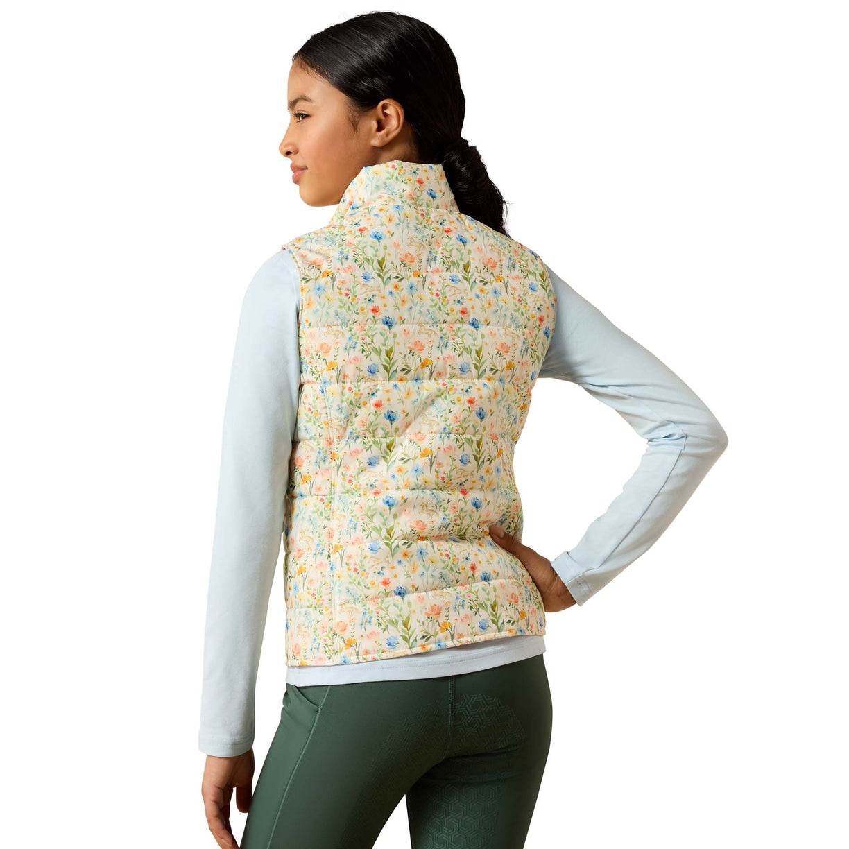 Woman wearing a floral patterned vest on a white background