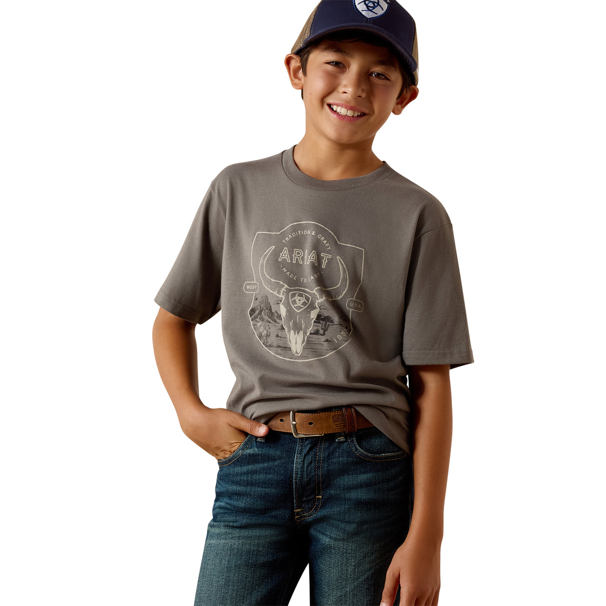 Child wearing a grey t-shirt with a logo and blue jeans