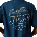 Boy wearing navy blue t-shirt with an eagle graphic and 'Ariat' branding