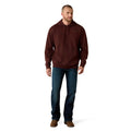 Man wearing a brown hoodie and blue jeans on a white background