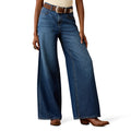 Person wearing blue jeans on a white background