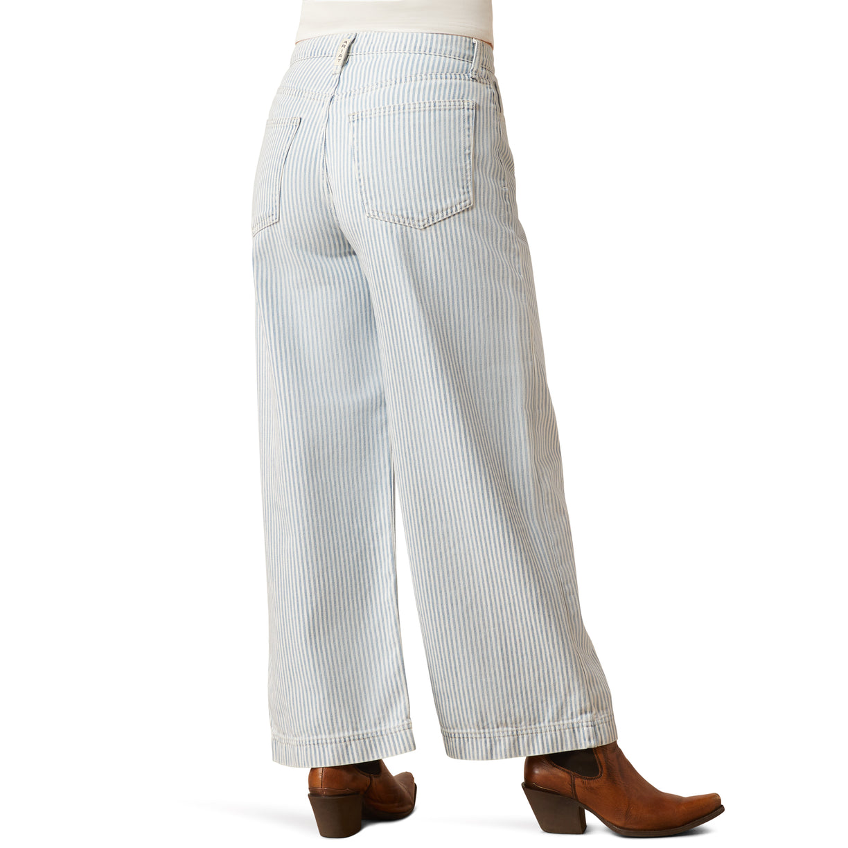 Light blue striped pants worn with brown boots on a white background