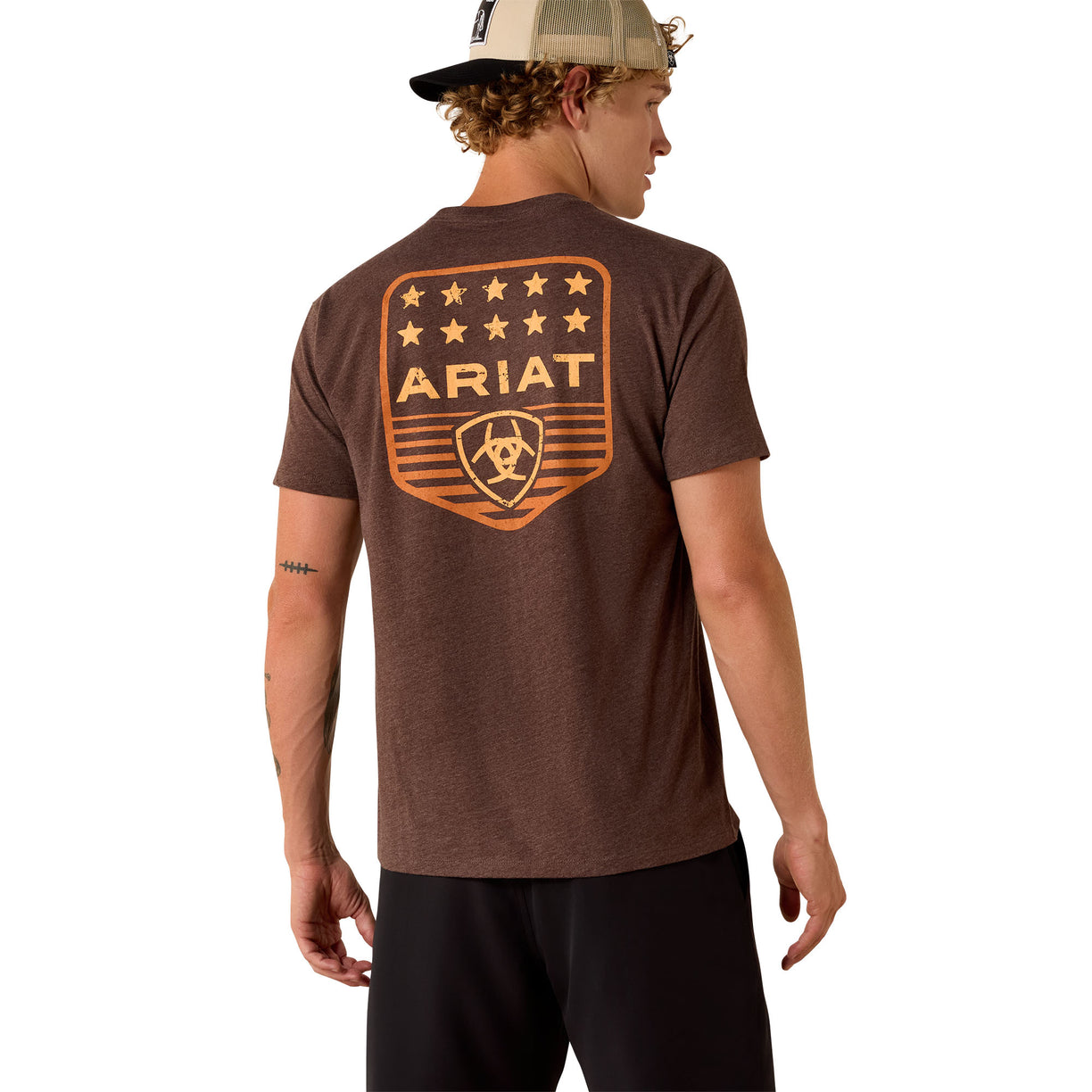 Man wearing a brown Ariat t-shirt with a logo on the back against a white background