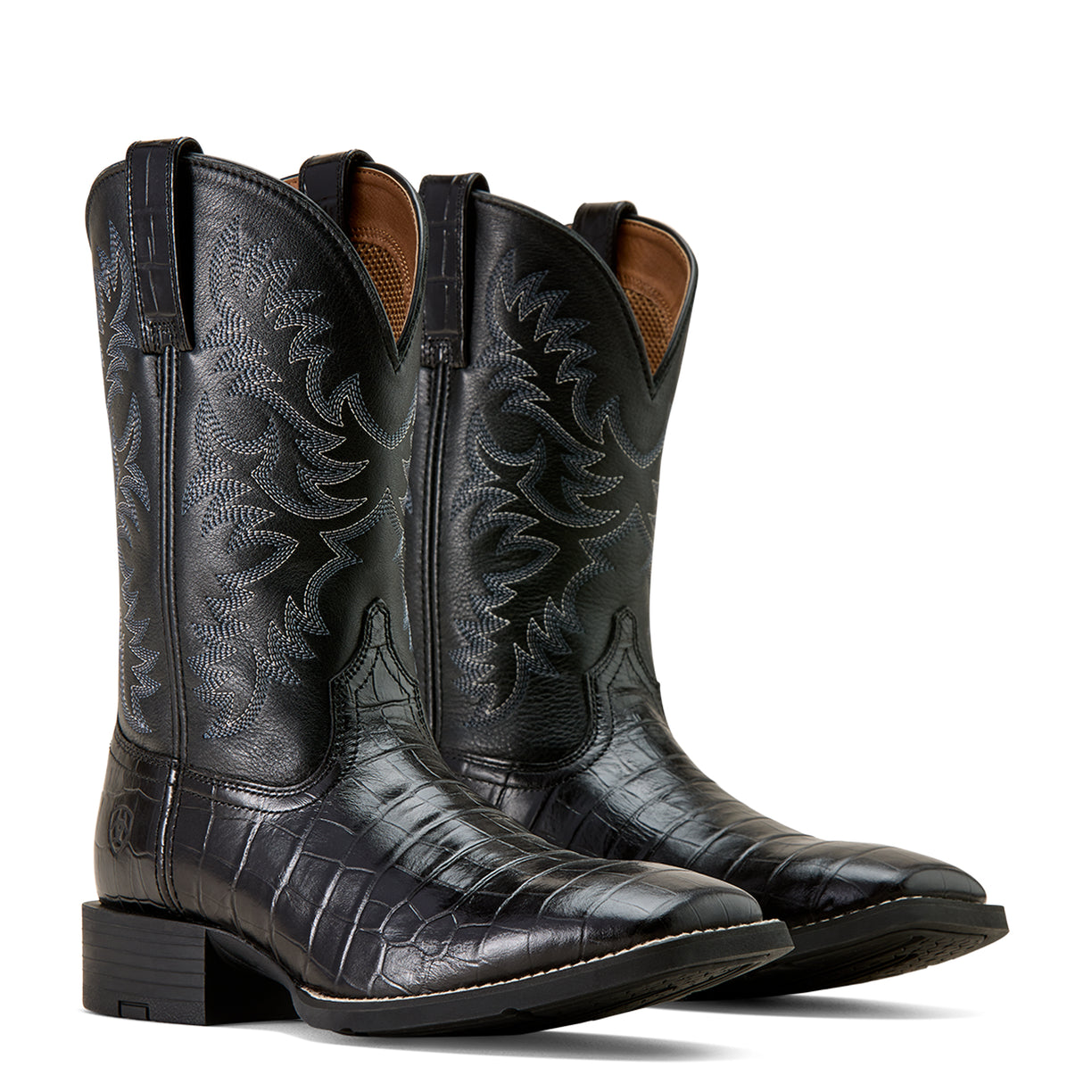 Pair of black leather cowboy boots with embossed design on a white background