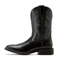 Black cowboy boot with embossed design on a white background