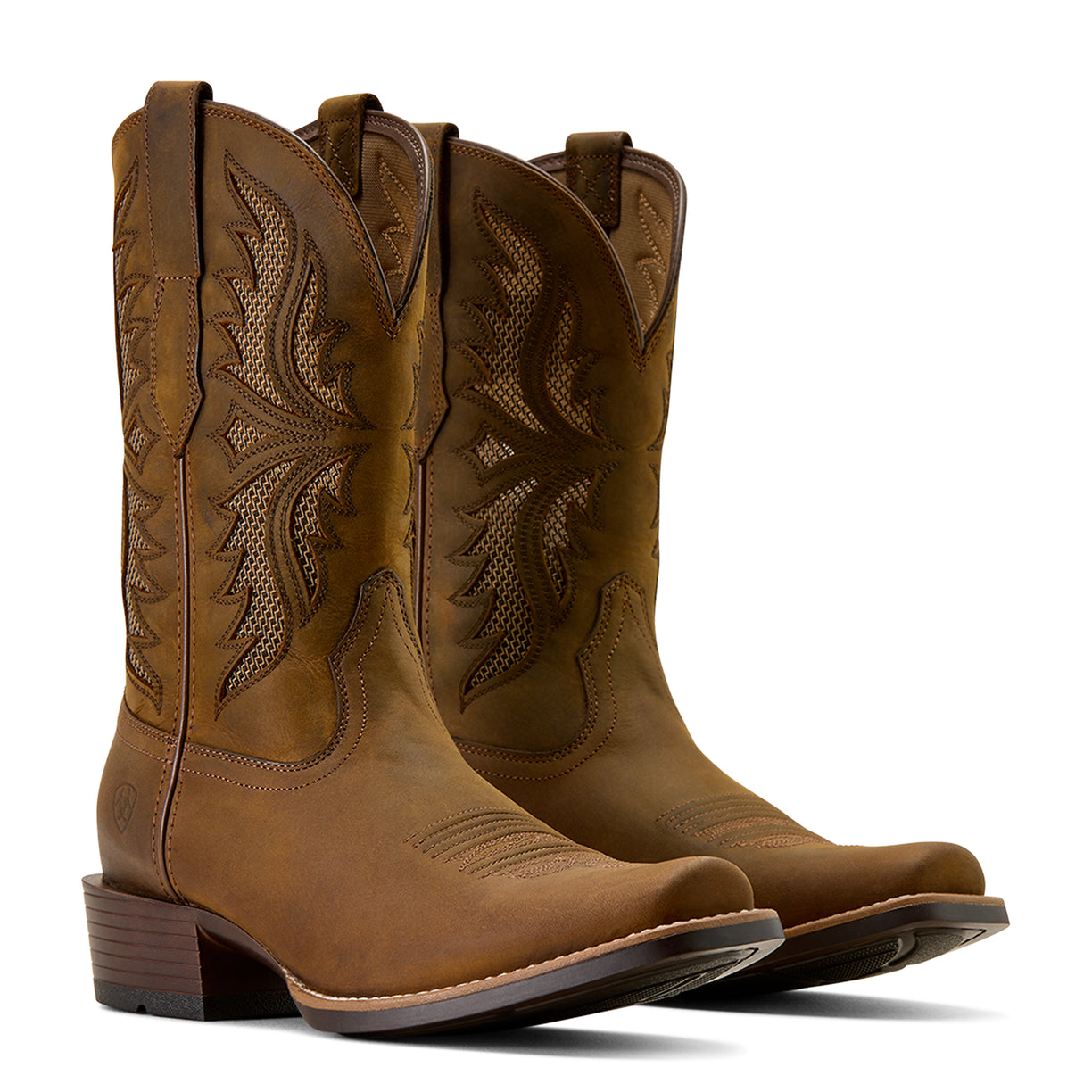 Pair of brown cowboy boots with intricate designs on a white background