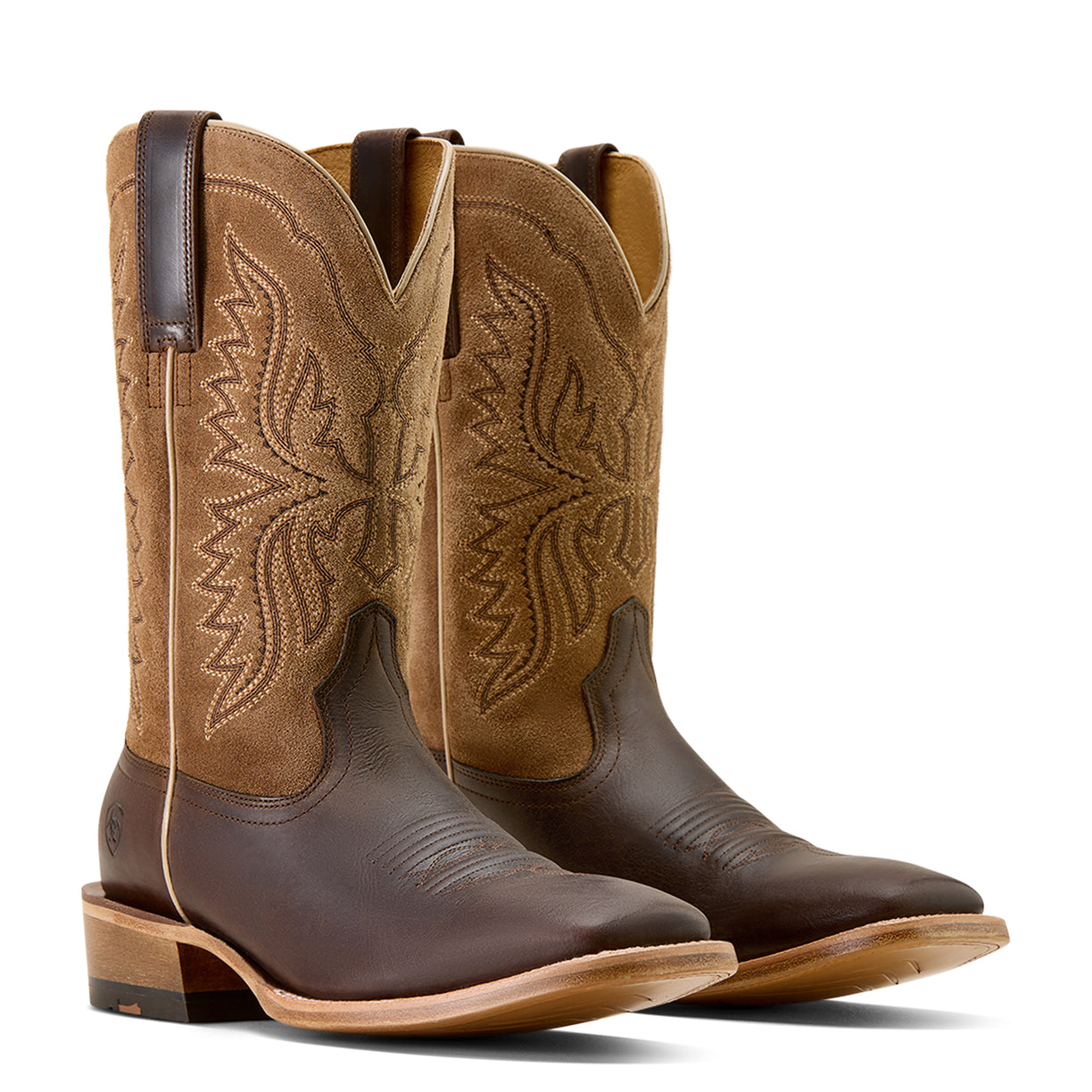 Pair of brown cowboy boots with intricate designs on a white background