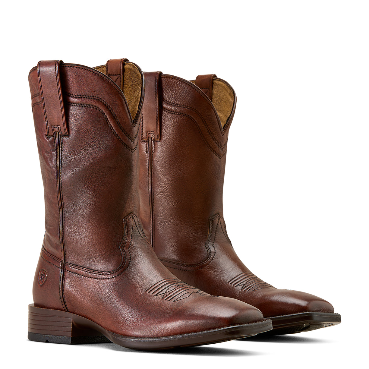 Pair of brown leather boots on a beige background