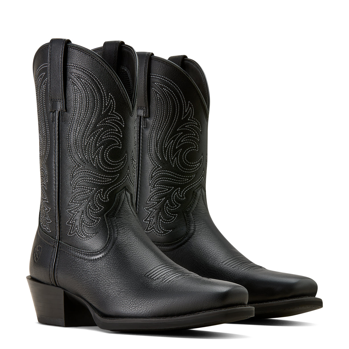 Pair of black cowboy boots with intricate designs on a white background