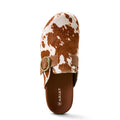 Brown and white cow print sandal with a gold buckle on a white background, featuring the Ariat brand.