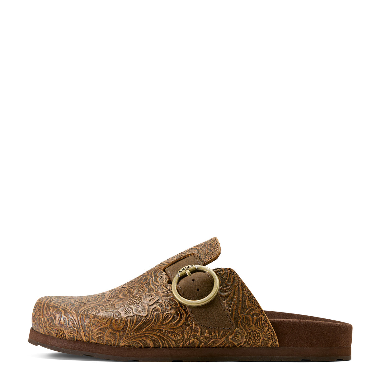 Brown leather clog shoe with floral embossing and a round buckle on a white background