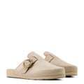 Beige clogs with a gold buckle on a white background
