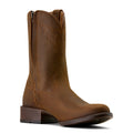 Brown leather boot on a beige background