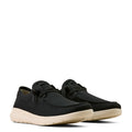 Black sneakers with beige soles on a white background