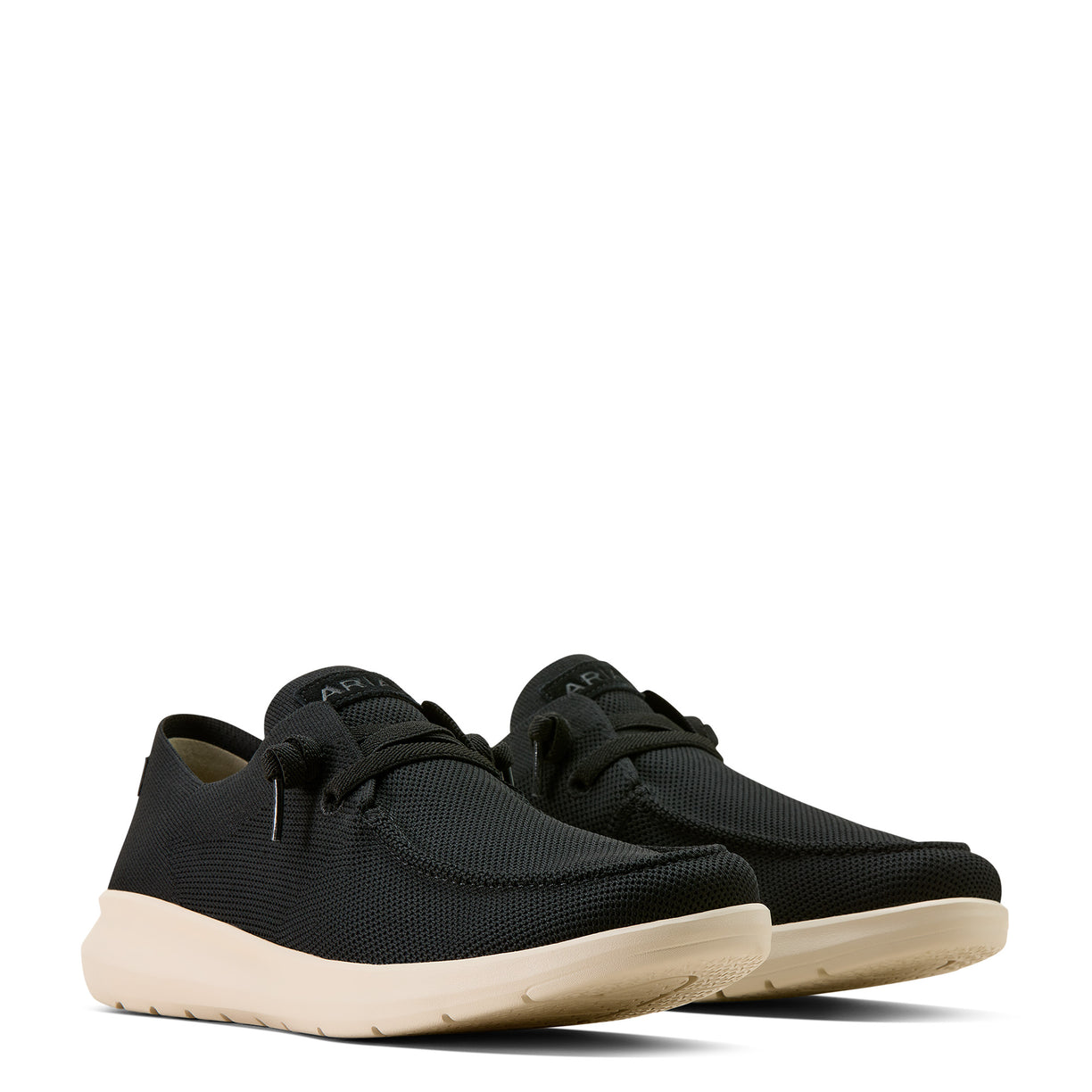 Black sneakers with beige soles on a white background