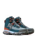 Pair of blue and gray hiking boots with orange accents on a light beige background
