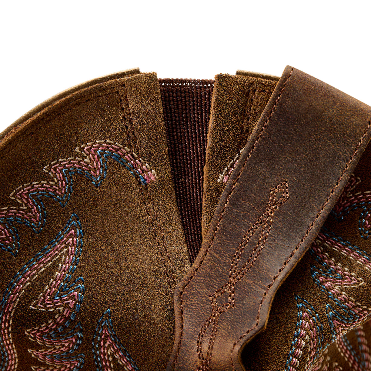 Close-up of brown leather boot with intricate stitching on a white background