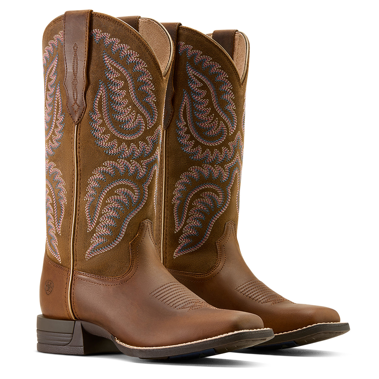 Pair of brown cowboy boots with intricate stitching on a white background