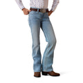 Person wearing light blue Ariat denim jeans and brown boots 