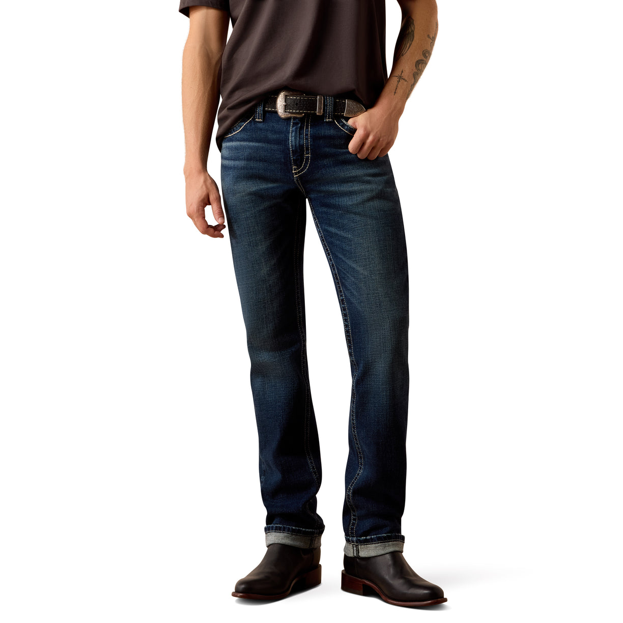 Person wearing dark blue Ariat jeans and brown boots.