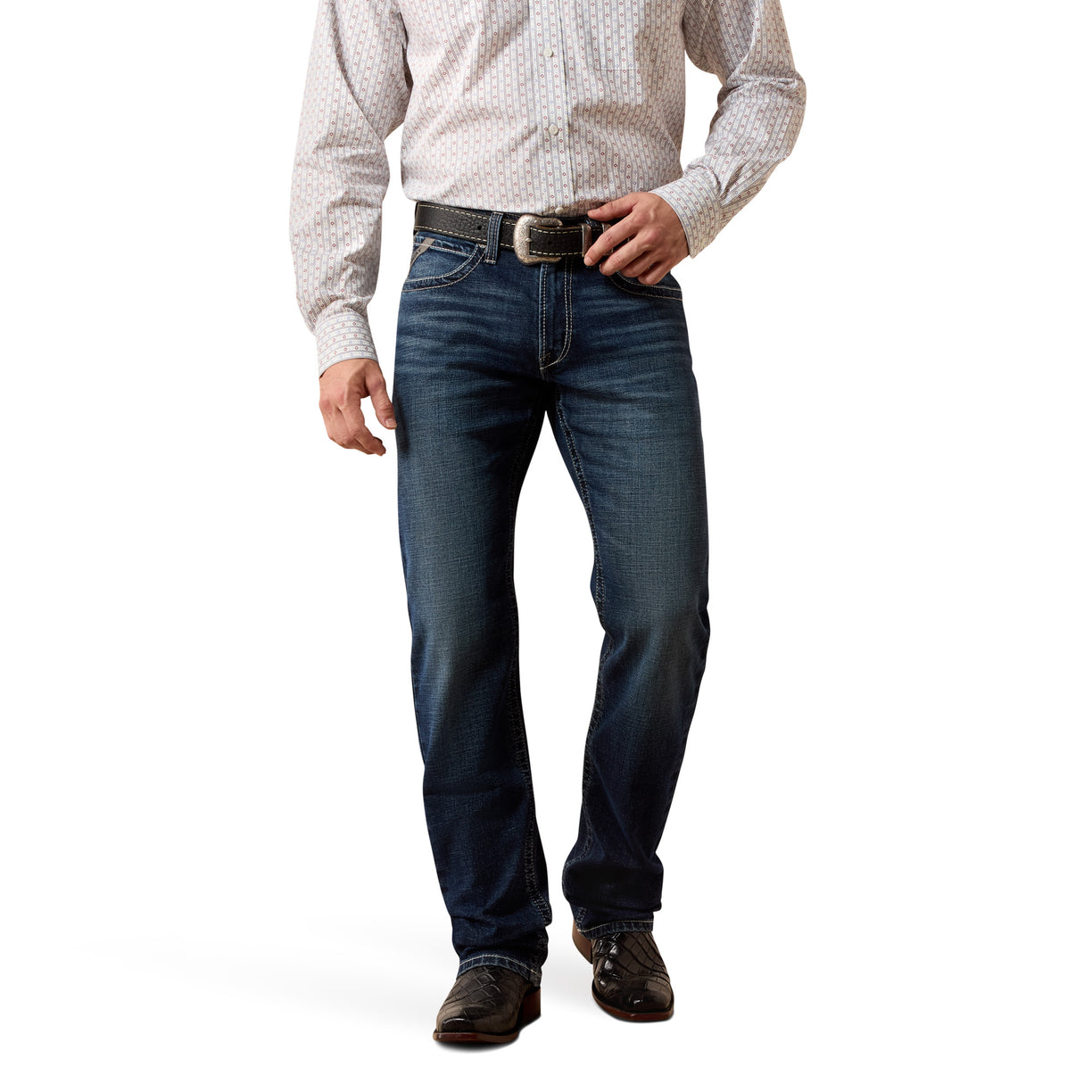 Man wearing a white patterned shirt and blue straight leg jeans on a white background