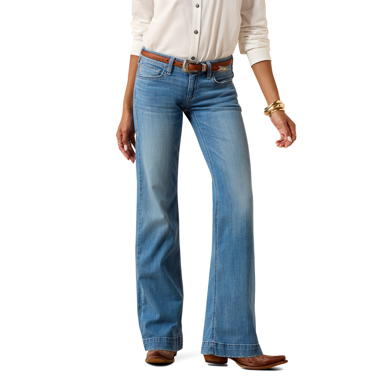 Person wearing blue Ariat trouser jeans with a white dress shirt on a white background