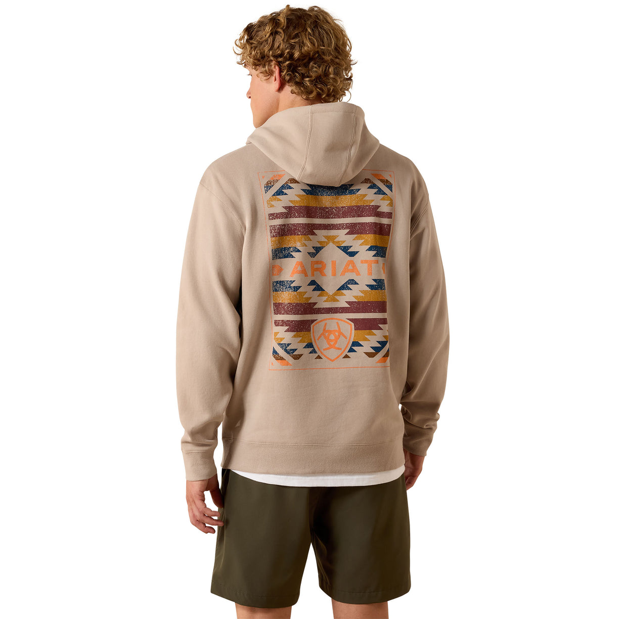 Person wearing a beige hoodie with a colorful back design and 'Ariat' branding on a white background