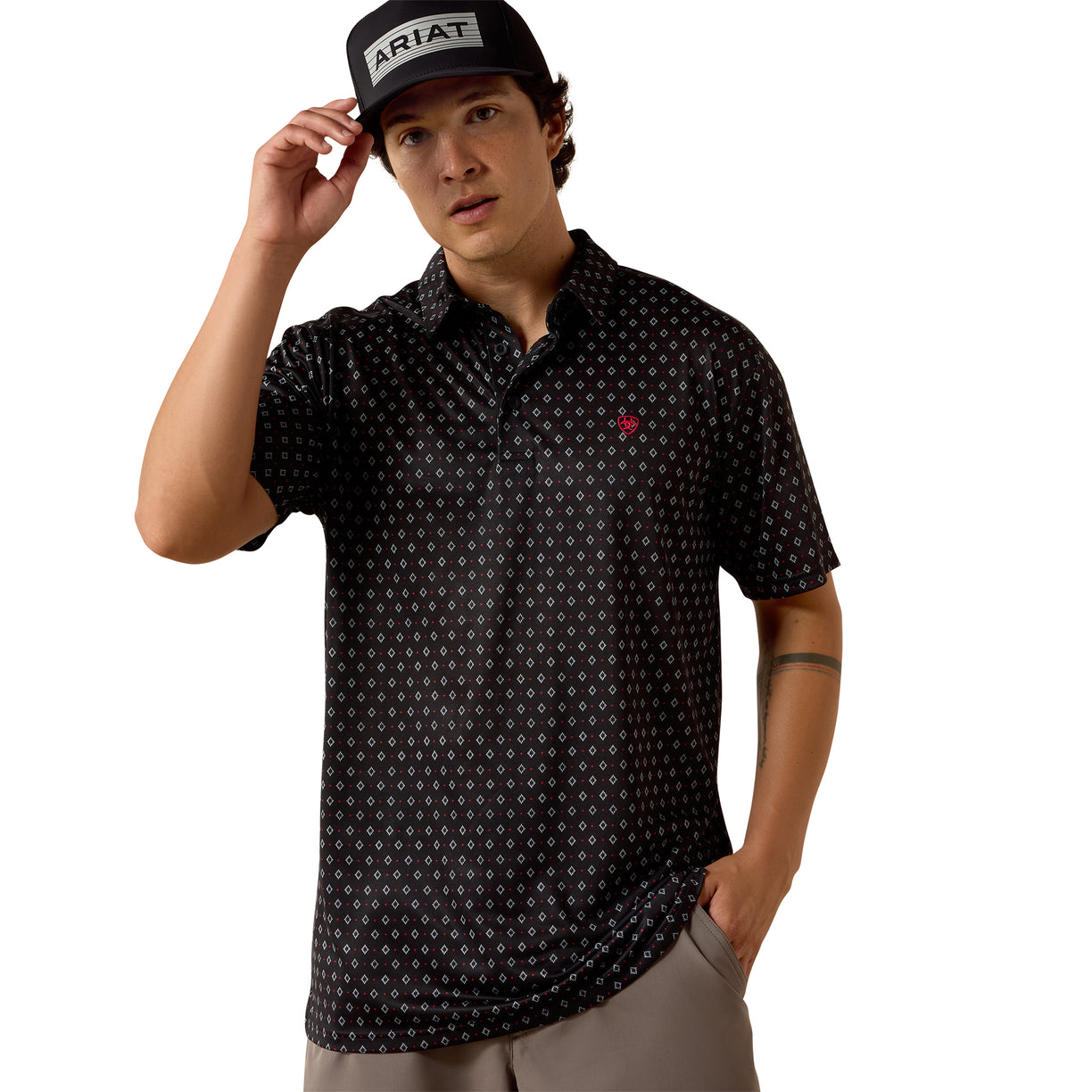 Black patterned polo shirt with embroidered logo, worn with an Ariat cap