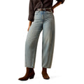 Light blue jeans worn by a model, paired with brown boots on a white background