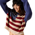 Woman wearing a sweater with an American flag design on a white background