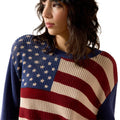 Person wearing a sweater with an American flag design on a white background